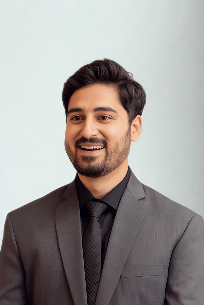 Najam Iftikhar wearing a grey suit